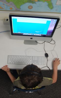 student sitting at a desktop computer