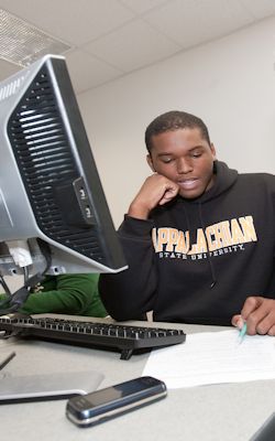 student sitting at a desktop computer